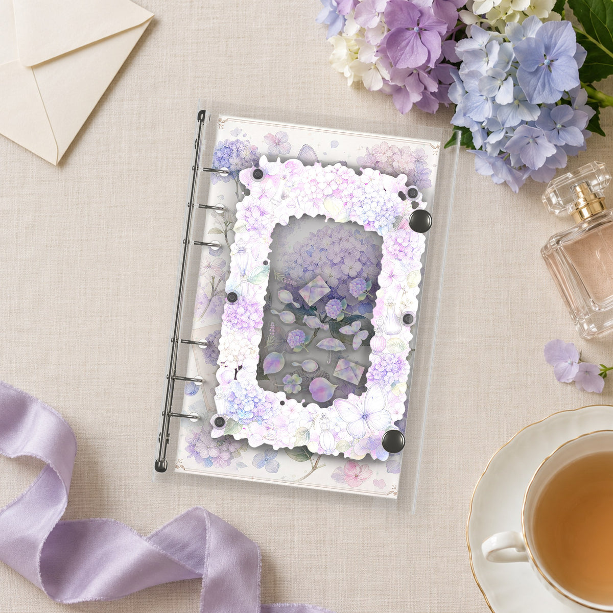 Hydrangea & Perfume shaker binder on a styled desk