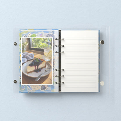 Inside: a photo sleeve and a lined refill page